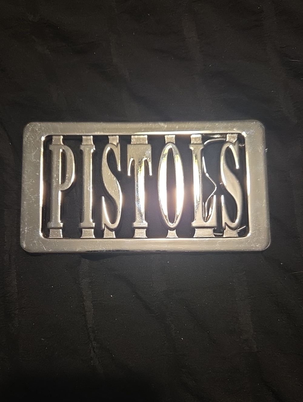 vintage metallic Sex Pistols belt buckle, featuring a polished chrome finish